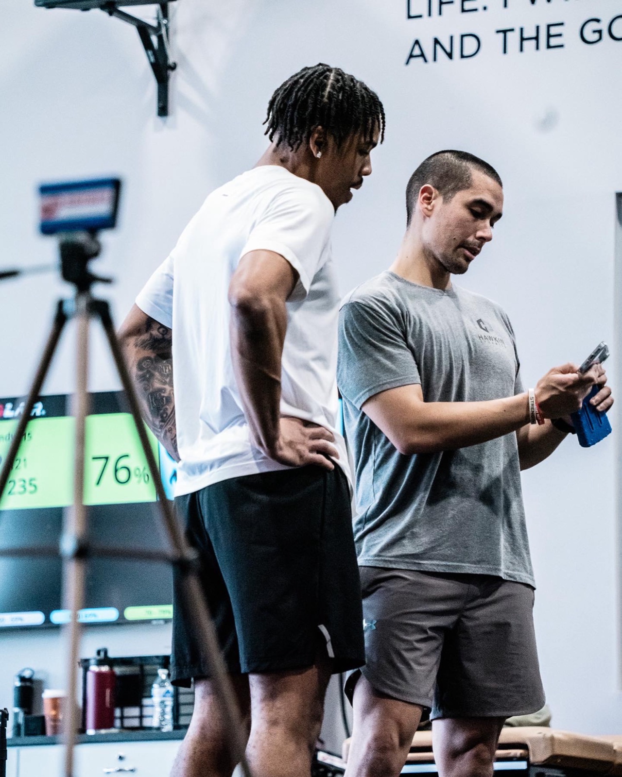 Rich Burnett reading a live test result with an athlete on the training floor